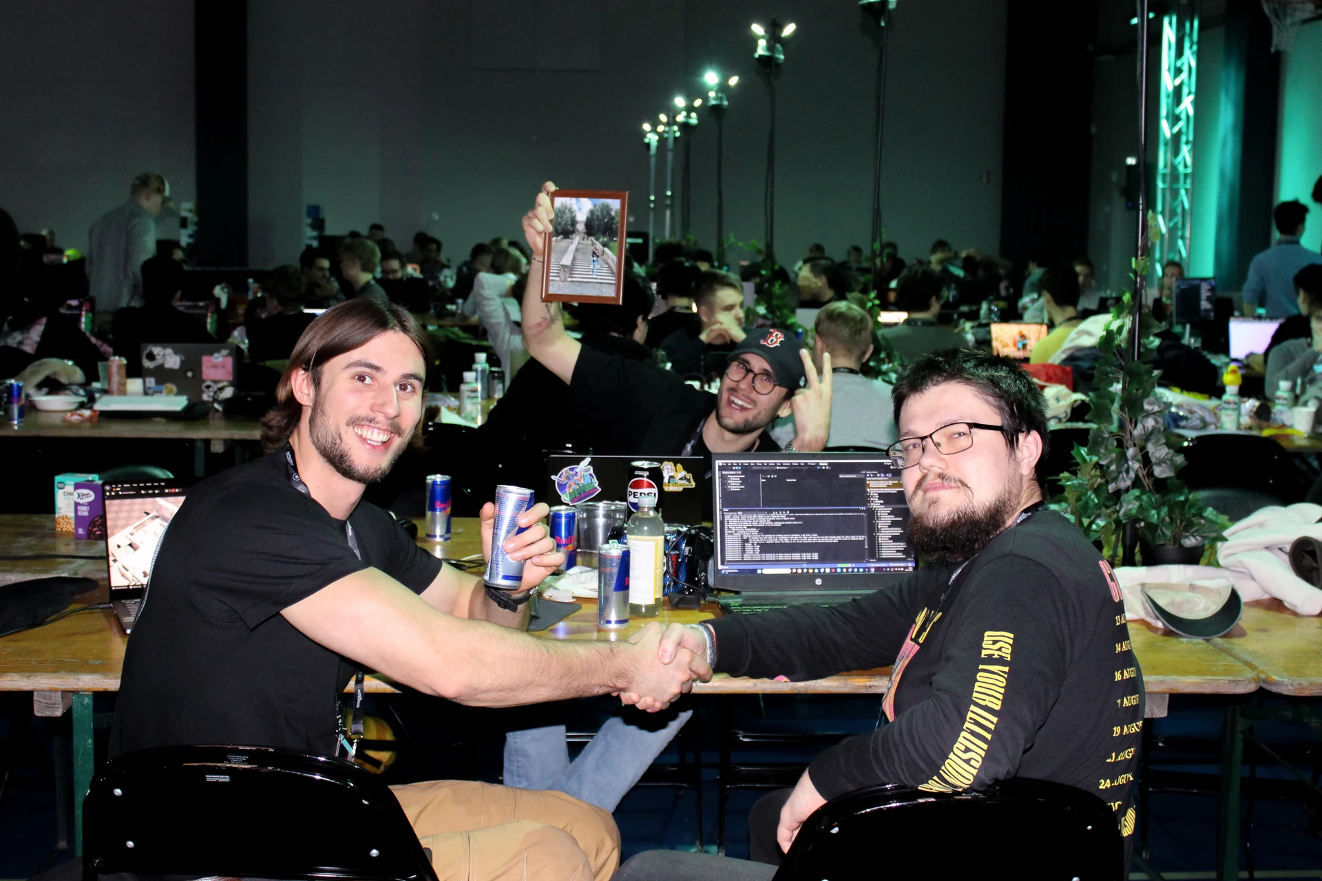 Junction 2025 participants connecting and shaking hands at their computers